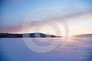 Winter landscape. Sunset on the frozen Lake Baikal