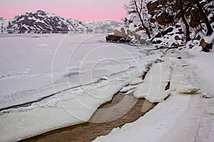 winter landscape with a sunset and the frozen river
