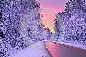 Winter landscape with sunset,road and forest