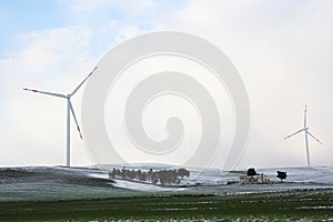Winter landscape with two wind turbines in a field, Daunian Mountains, Puglia, Italy