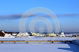 Winter landscape, urban bridge across the river on a sunny day.