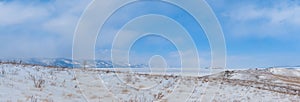 Winter landscape. View of the mountains and frozen Lake Baikal from the Ogoy island. Siberia, Russia