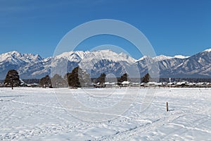Winter landscape with views of the mountains and a small village
