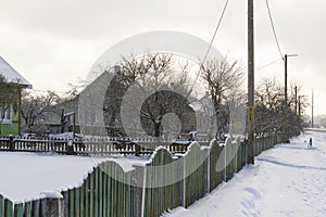 Winter landscape in the village in Belarus. Snowy street during a snowfall