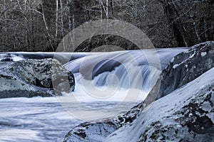 Winter landscape of waterfall and bare trees