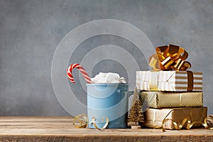 Winter lifestyle with cup of hot cocoa with marshmallows and Christmas gift or present boxes and holiday decorations