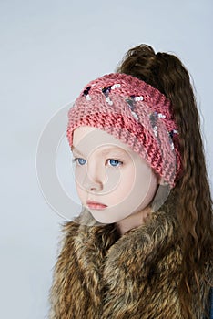 Winter little girl in fur and hat