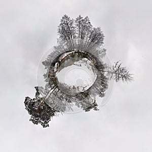 Winter little planet transformation of spherical panorama 360 degrees. Spherical abstract aerial view in forest. Curvature of