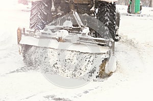 Winter, a lot of snow. The tractor clears the snow.