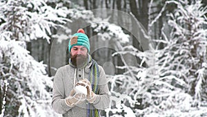 Winter man with snow ball fight outdoor in snow forest.
