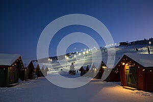Winter market village in Levi, Finland in the evenig on ski cable way background