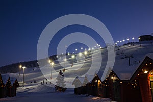 Winter market village in Levi, Finland in the evenig on ski cable way background