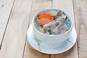 Winter melon soup with pork spare rib on wood background.