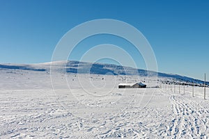 Winter morning, road to Meadow Hut, krkonose mountains. Along the road are wooden long bars, tourist markings for winter season