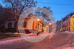 Winter morning view of colourful buildings on empty Andriyivskyy Uzvoz Descent or Spusk. One of the oldest street in Kyiv photo