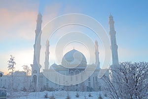 Winter mosque on the background of blue sky