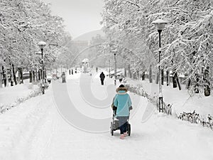 Winter, mother with stroller outdoor