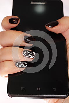 Winter motifs on nails on a smartphone background