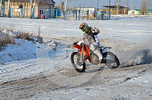 Winter motocross, rider on bike is accelerating photo