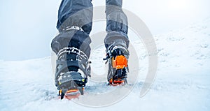 Winter mountain ascending in boot crampons