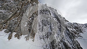 Winter mountain cliff summit structure stone ridge snow environment valley scenery aerial view