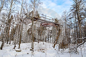 In winter in the mountain forest an old ski lift