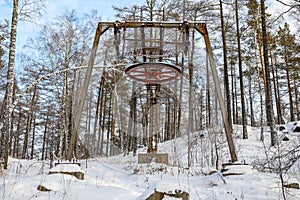 In winter in the mountain forest an old ski lift