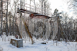 In winter in the mountain forest an old ski lift