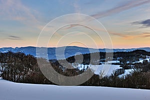 Winter mountain landscape at dusk with beautiful hills.