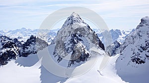 Winter mountain landscape in the Silvretta mountain range in the Swiss Alps with famous Piz Buin mountain peak in the center