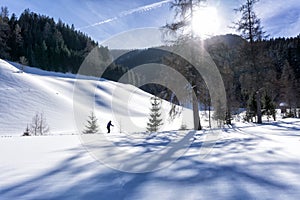 Winter mountain landscape in sunny day with single cross-country skier in Filzmoos Valley, Salzburg Alps,  Austria, Europe.