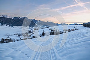 Winter mountain landscape at sunrise. Walchsee village.