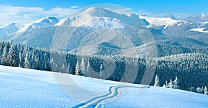 Winter mountain panorama with ski track