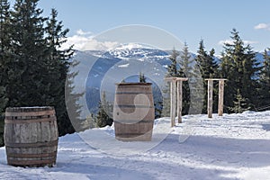 Winter mountain ski resort Pamporovo, Bulgaria. vintage outdoor cafe, snowy forest, mountains, blue sky. Winter vacation