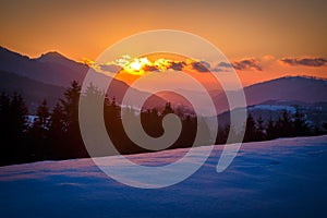 Winter mountain snowy landscape at sunset