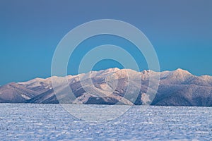 Winter mountain snowy landscape at sunset