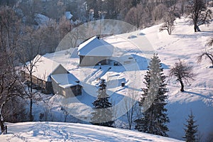 Winter mountain village landscape with snow and houses.