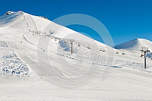 Winter mountains background with ski slopes and ski lifts. Skiing resort. Extreme sport. Active holiday. Free time concept.