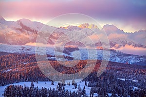 Winter mountains. Beautiful landscape with snowy summits in pink morning sunlight.