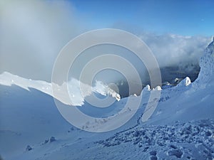 Winter in the mountains. Hiking during wintertime. Snow storm in the high mountains