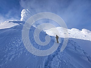 Winter in the mountains. Hiking during wintertime. Snow storm in the high mountains