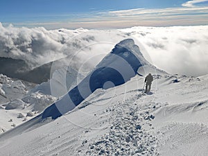 Winter in the mountains. Hiking during wintertime. Snow storm in the high mountains