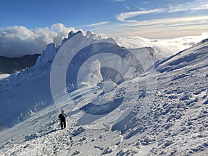 Winter in the mountains. Hiking during wintertime. Snow storm in the high mountains