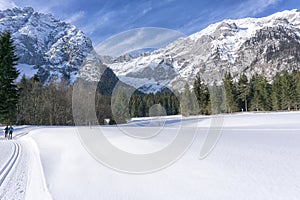 Winter mountains landscape with groomed ski track
