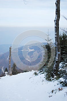 Winter mountains landscape with smog from city in background.