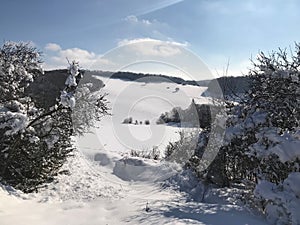 Snow blanket covers the hills in a countryside in winter