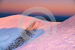 Winter mountains ridge in orange sunrise light