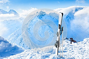 Winter mountains and ski equipment in the snow