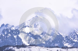 mountains under fresh snow in the city of Almaty in Kazakhstan. Bukreev Peak above the city