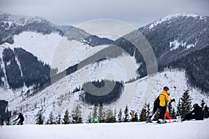 Winter mountains view ski resort slopes people skiing and snowboarding